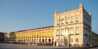 Das prunkvolle, gelbe Gebäude des portguiesischen Finanzministeriums in Lissabon leuchtet in der Sonne.